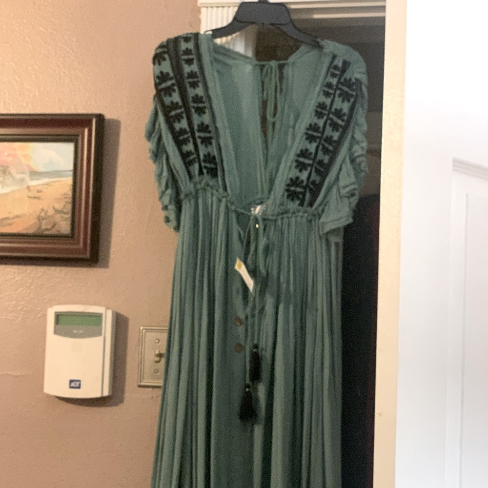 Long green dress with buttons down the front can be used for a cover or a dress